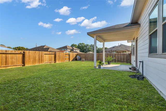 a view of a house with yard and a garden