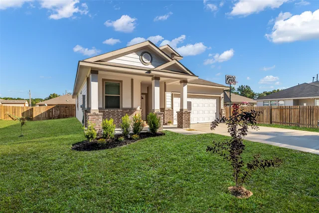 a view of a backyard with table and chairs and floor to ceiling window