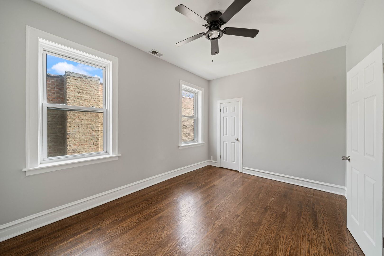 5426 West Jackson Boulevard, Unit 2 Chicago, IL 60644 - Photo 6 of 10 a view of an empty room with wooden floor and a window