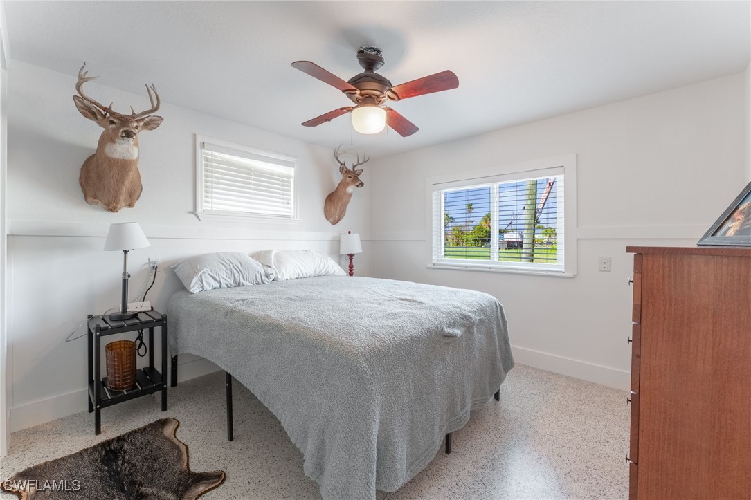 16341 Porto Bello Street Bokeelia, FL 33922 - Photo 12 of 50 a bedroom with a bed and a chandelier