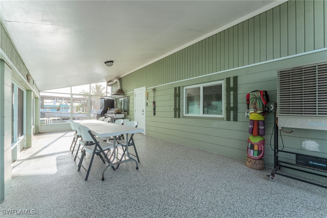 16341 Porto Bello Street Bokeelia, FL 33922 - Photo 17 of 50 a dining room with furniture and a window