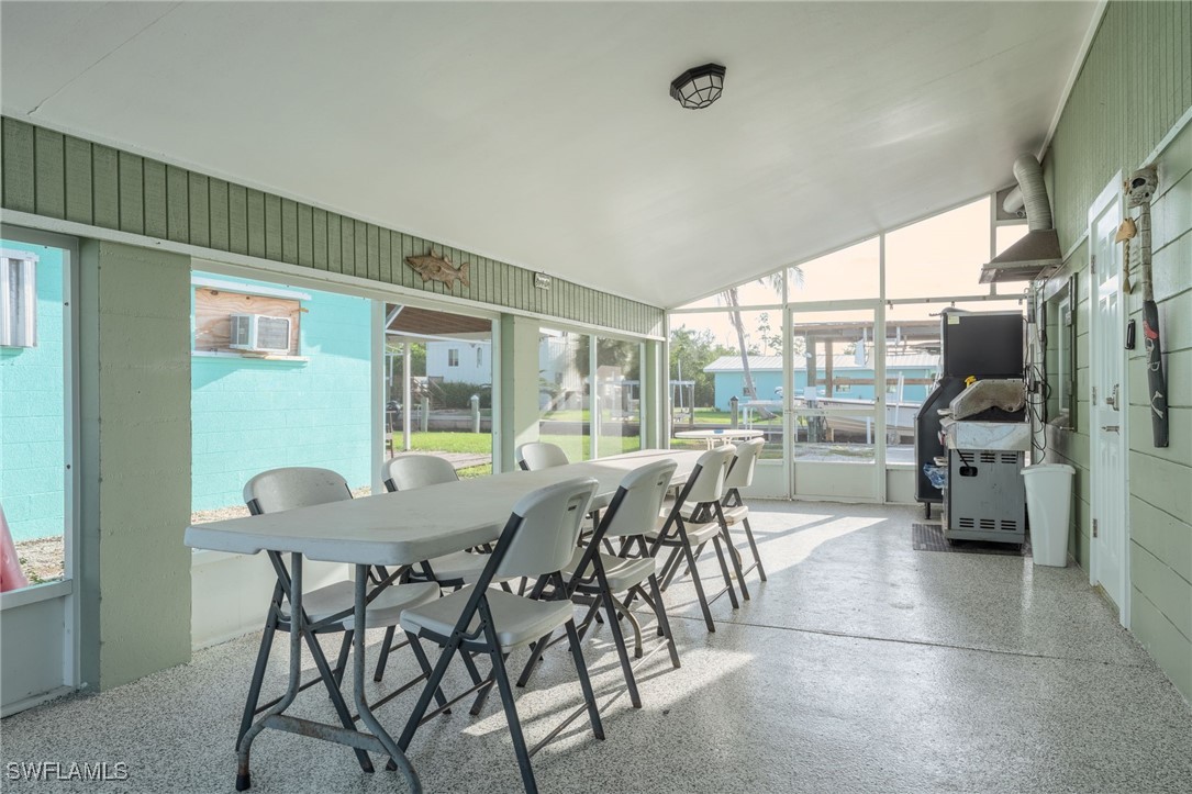 16341 Porto Bello Street Bokeelia, FL 33922 - Photo 18 of 50 a view of a dining room with furniture window and outside view