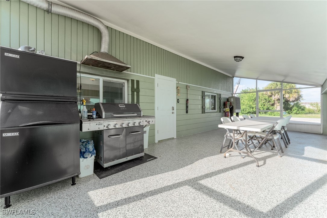 16341 Porto Bello Street Bokeelia, FL 33922 - Photo 19 of 50 a kitchen with a stove and a refrigerator