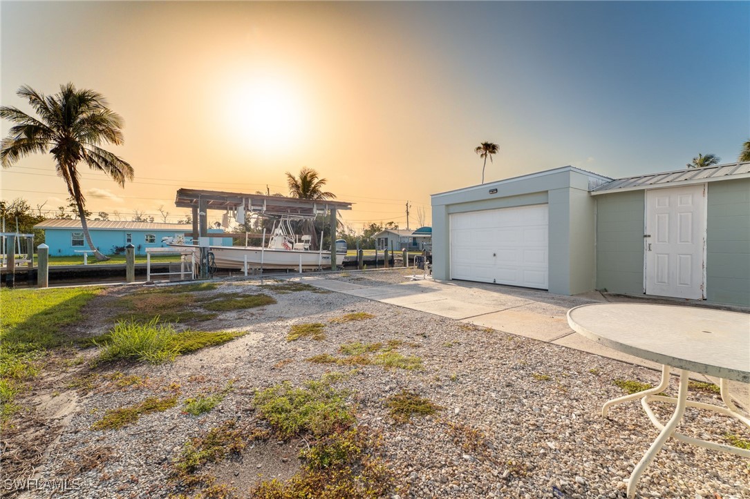 16341 Porto Bello Street Bokeelia, FL 33922 - Photo 20 of 50 a house view with a backyard space