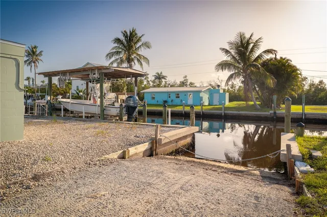 a view of a swimming pool with a table and chairs under an umbrella