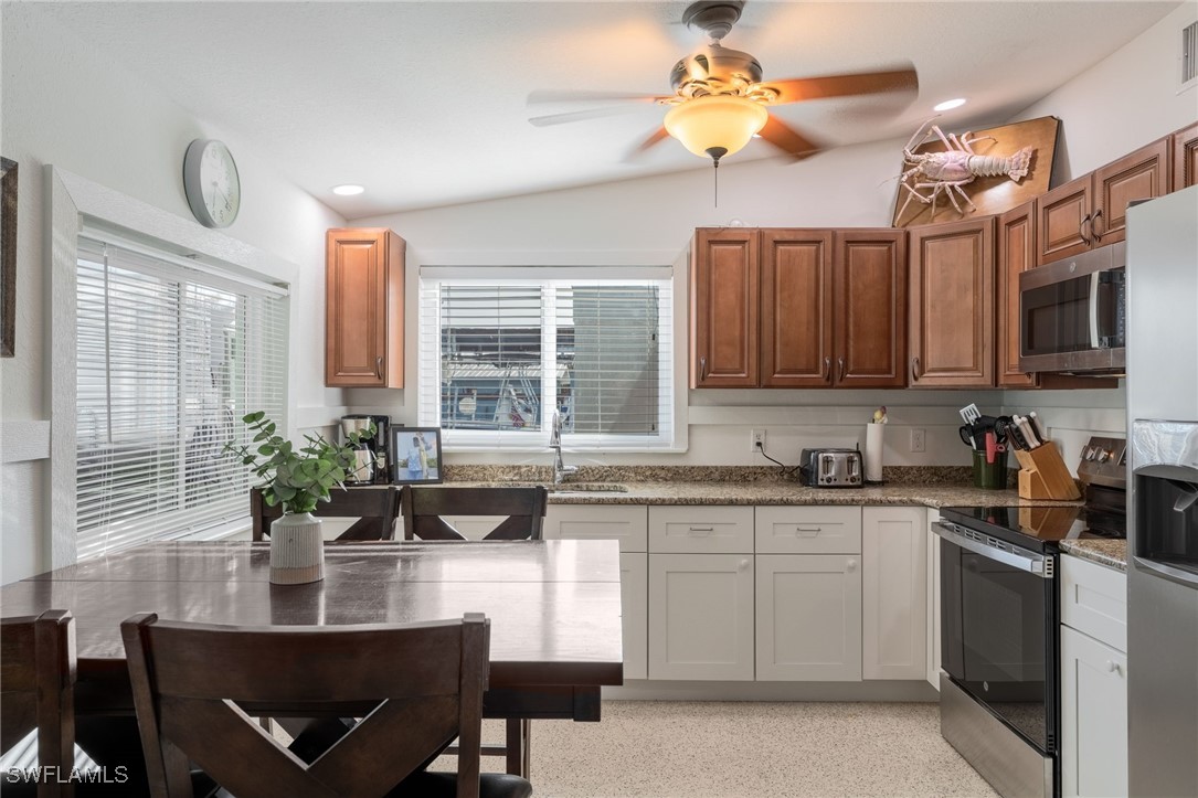 16341 Porto Bello Street Bokeelia, FL 33922 - Photo 3 of 50 a kitchen with a stove a sink and cabinets