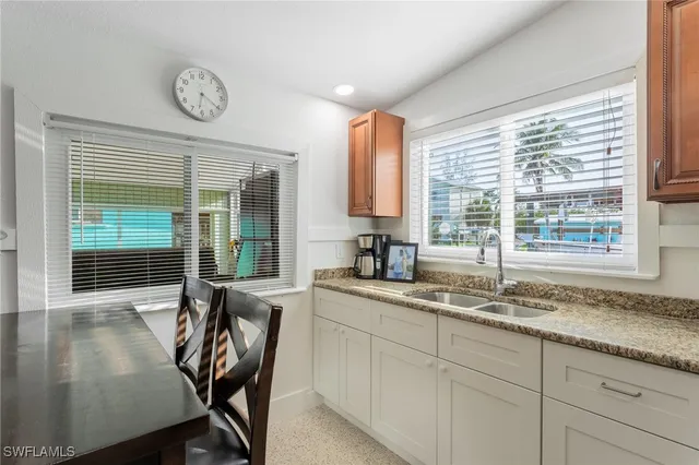 a kitchen with a table chairs and a window