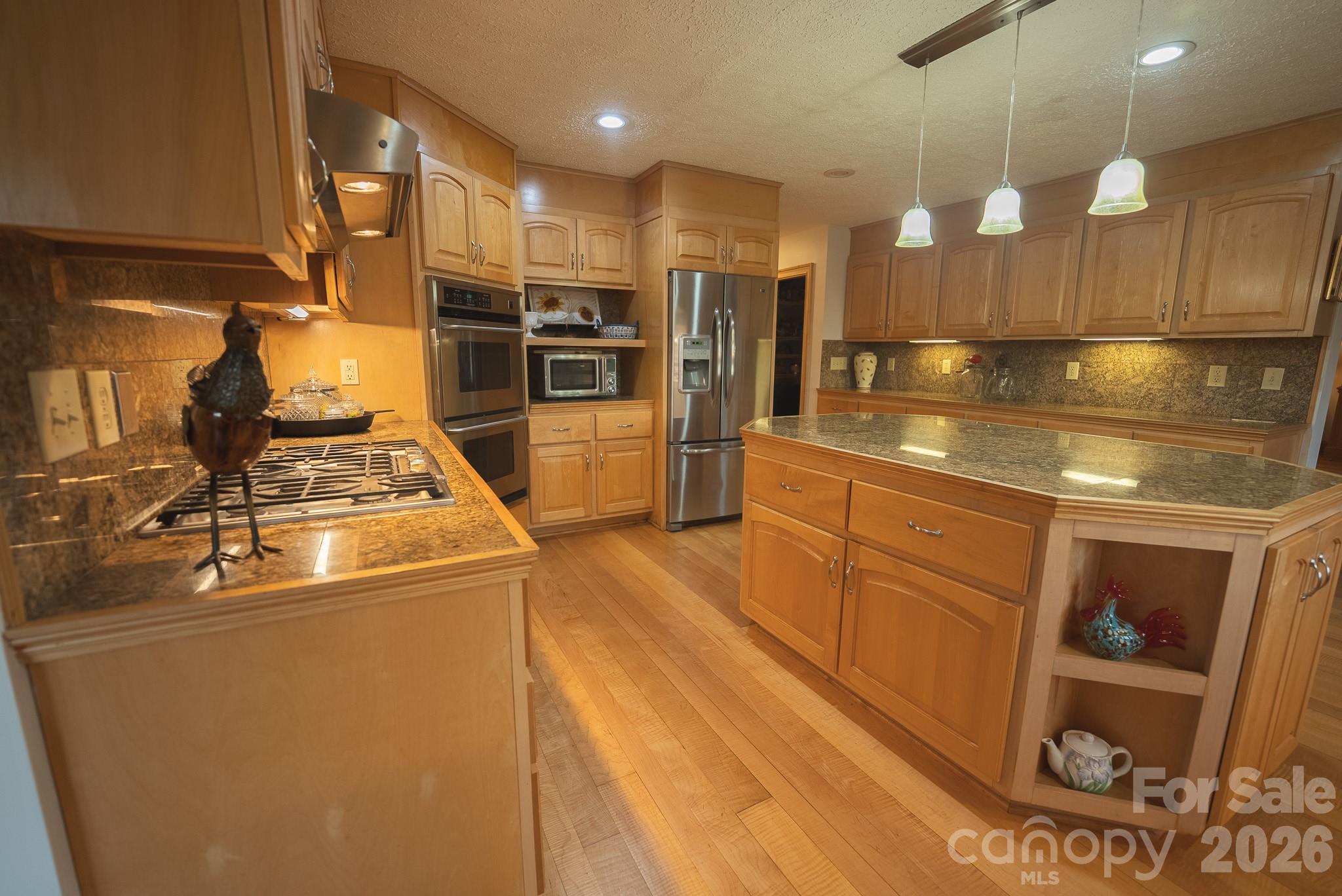 6985 Junaluska Road Boone, NC 28607 - Photo 27 of 35 a view of a kitchen with refrigerator and wooden floor