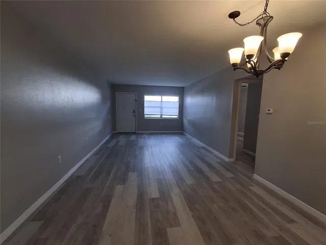 a view of a room with wooden floor