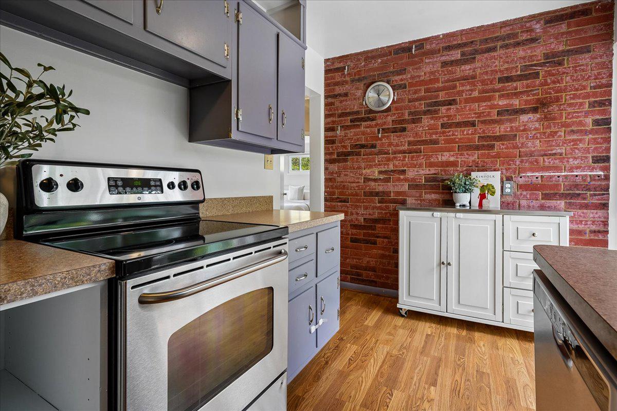 104 Belton Road Silver Spring, MD 20901 - Photo 25 of 56 a kitchen with stainless steel appliances granite countertop a stove and a microwave