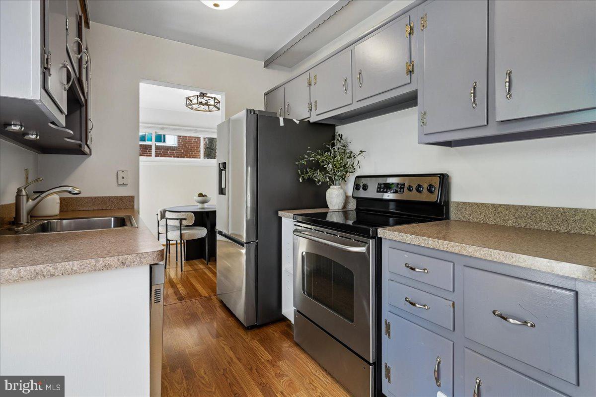 104 Belton Road Silver Spring, MD 20901 - Photo 29 of 56 a kitchen with granite countertop a sink cabinets and stainless steel appliances