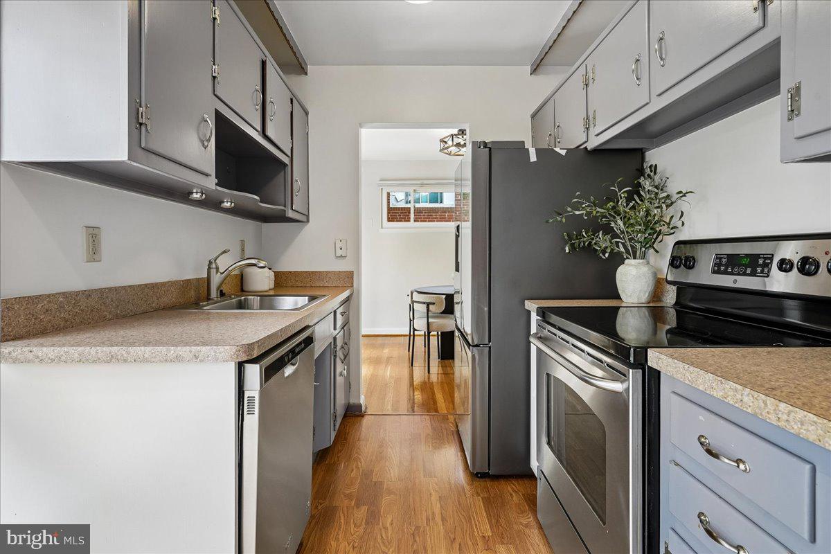 104 Belton Road Silver Spring, MD 20901 - Photo 30 of 56 a kitchen with stainless steel appliances granite countertop a refrigerator a stove and a microwave