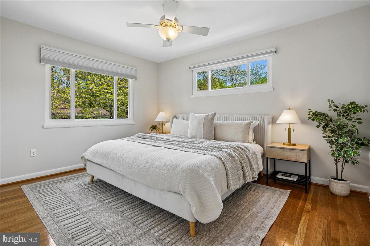 104 Belton Road Silver Spring, MD 20901 - Photo 31 of 56 a bedroom with a large bed and a chandelier