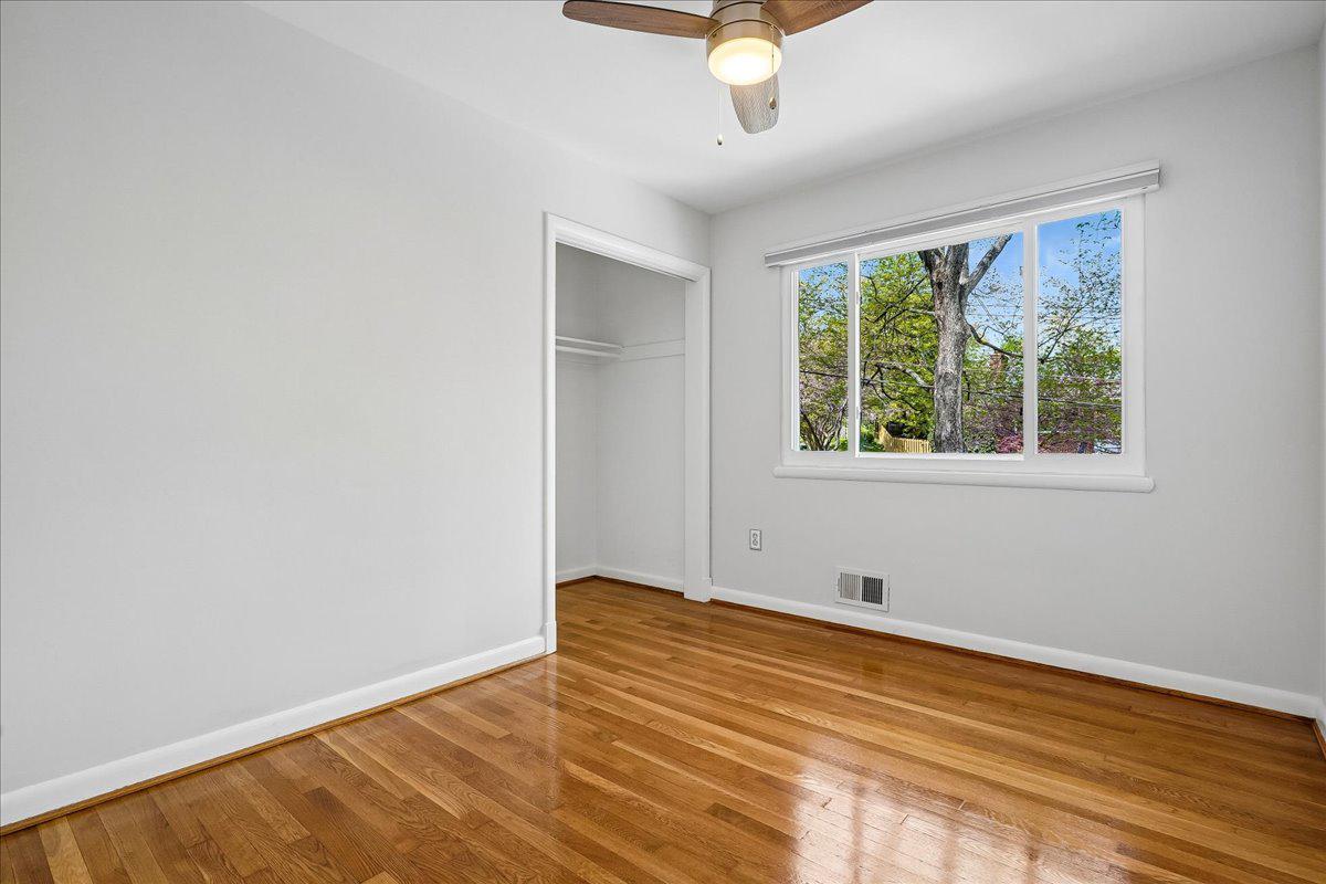 104 Belton Road Silver Spring, MD 20901 - Photo 35 of 56 a view of empty room with wooden floor and fan