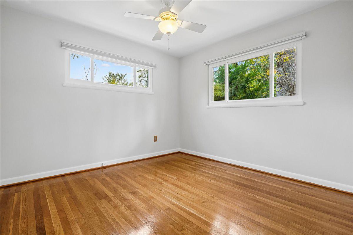 104 Belton Road Silver Spring, MD 20901 - Photo 38 of 56 a view of an empty room with window and wooden floor