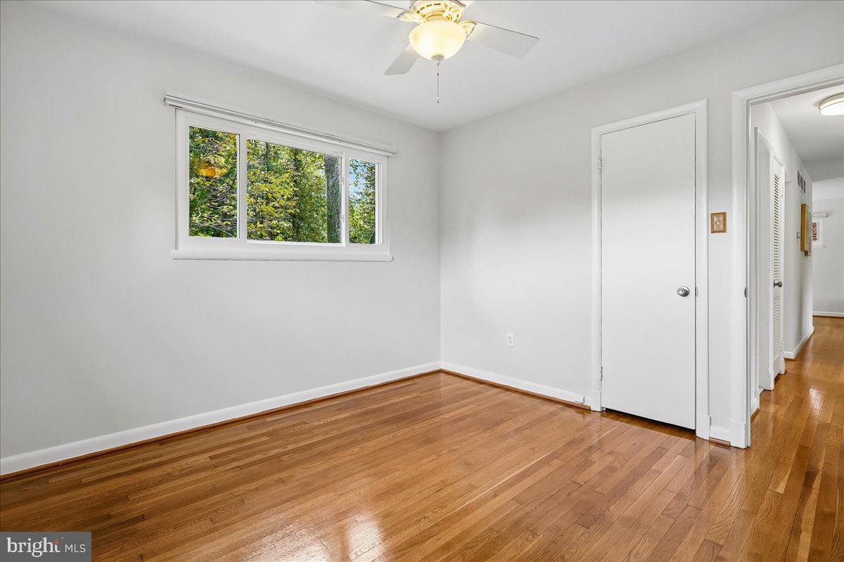 104 Belton Road Silver Spring, MD 20901 - Photo 40 of 56 a view of an empty room with wooden floor and a window