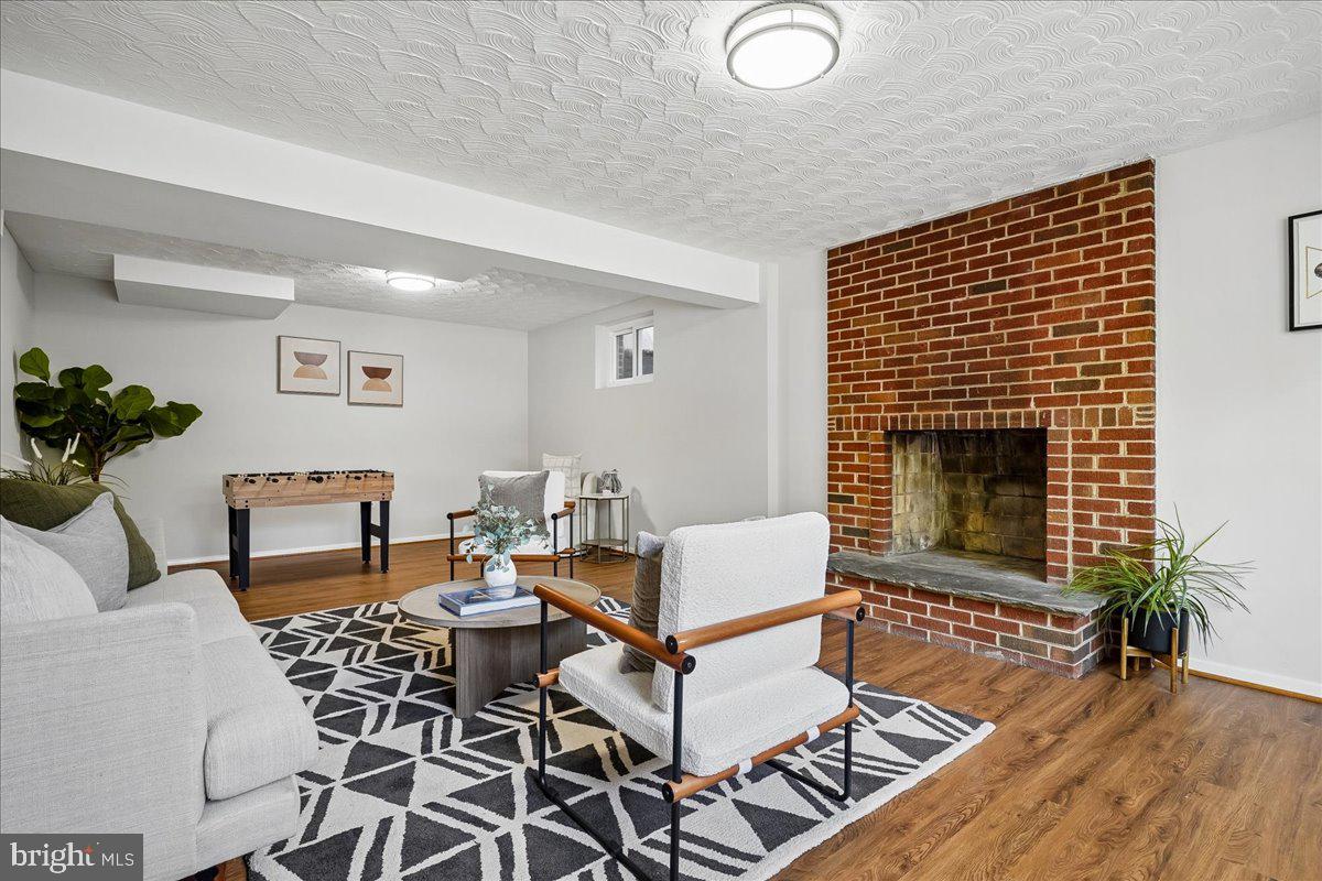 104 Belton Road Silver Spring, MD 20901 - Photo 7 of 56 a living room with furniture a fireplace and wooden floor