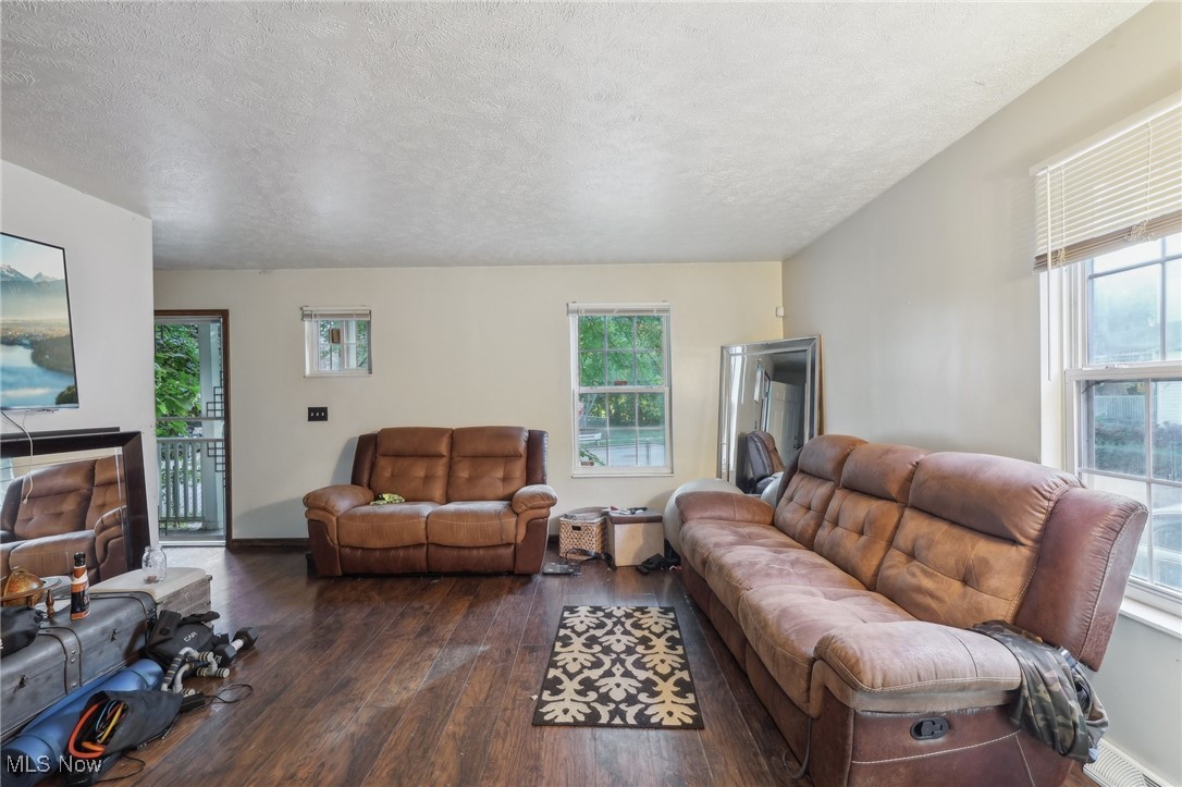 1042 Ansel Road Cleveland, OH 44103 - Photo 12 of 36 Living room featuring a textured ceiling, plenty of natural light, and dark hardwood / wood-style flooring