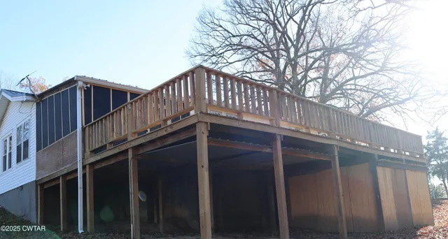a view of wooden house with a large window