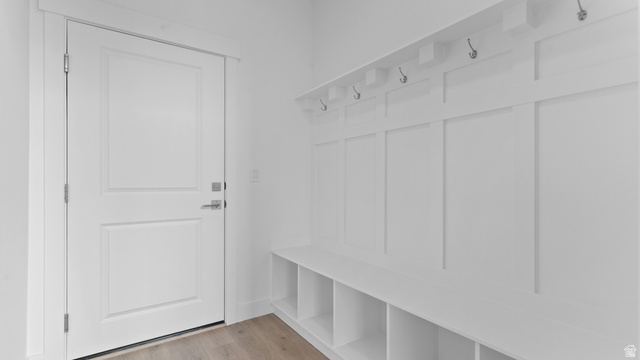 4170 North 560th West, Unit 6 Tooele, UT 84074 - Photo 20 of 20 Mudroom featuring white board and batten paneling, built-in bench with cubbies, and integrated coat hooks