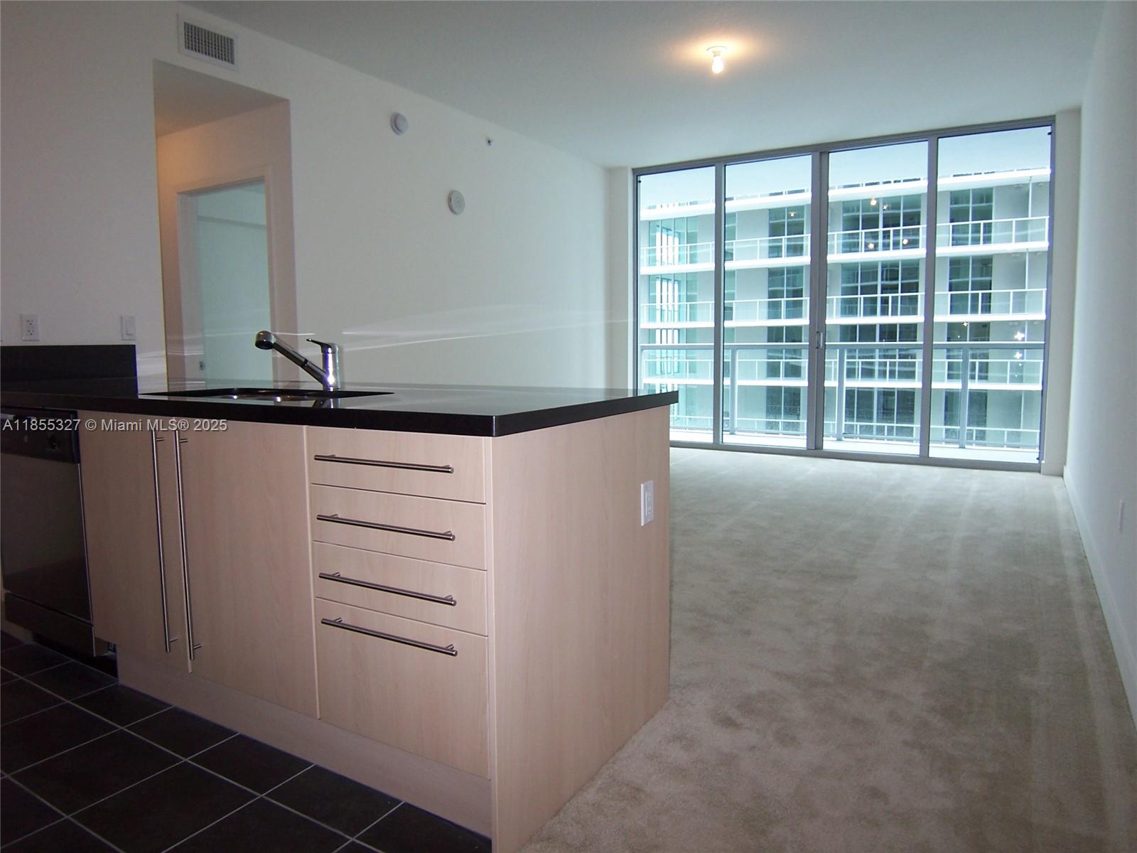 1111 Southwest 1st Avenue, Unit 3415N Miami, FL 33130 - Photo 2 of 11 a view of an empty room with a window