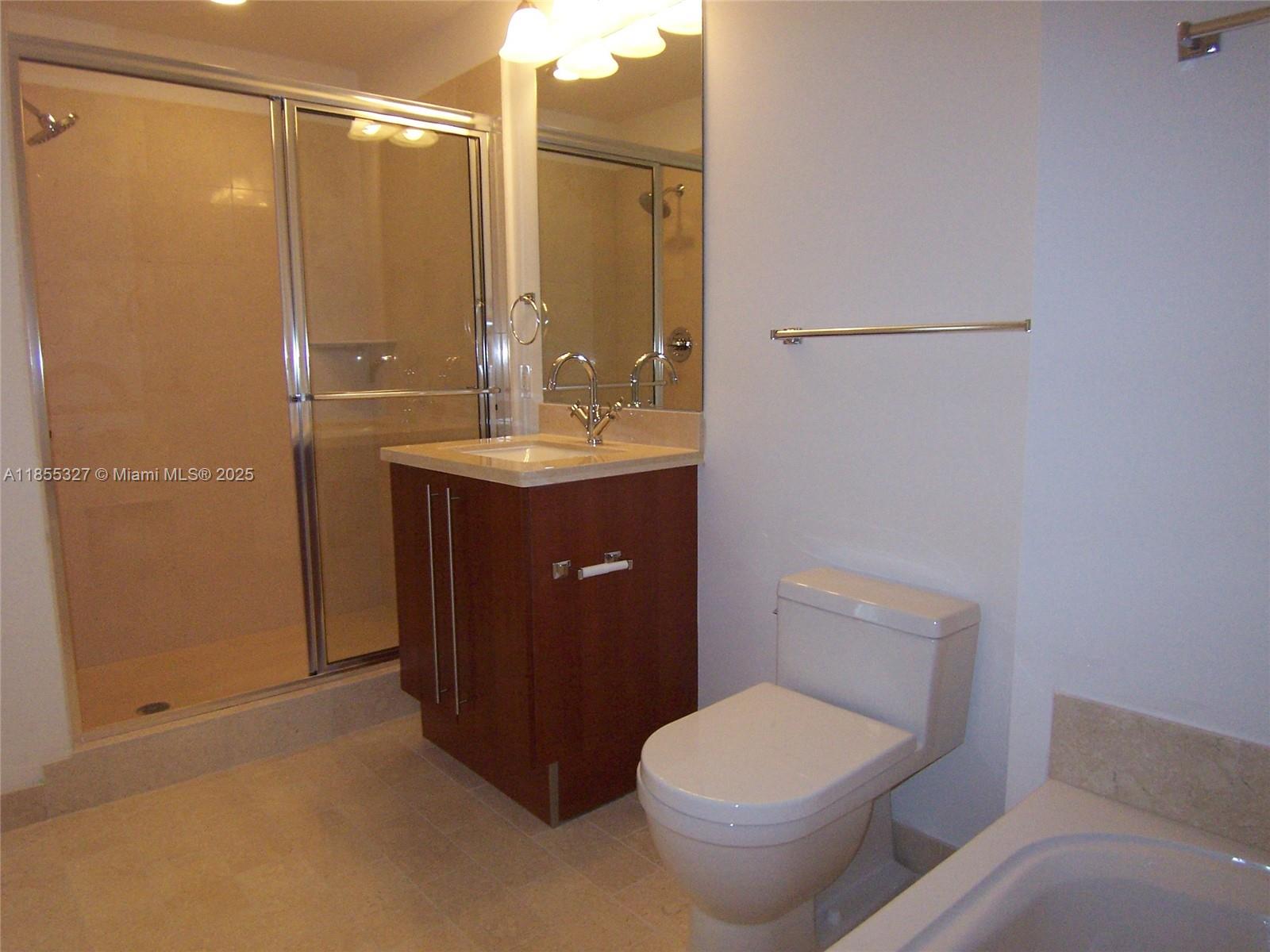 1111 Southwest 1st Avenue, Unit 3415N Miami, FL 33130 - Photo 6 of 11 a bathroom with a toilet a sink and shower
