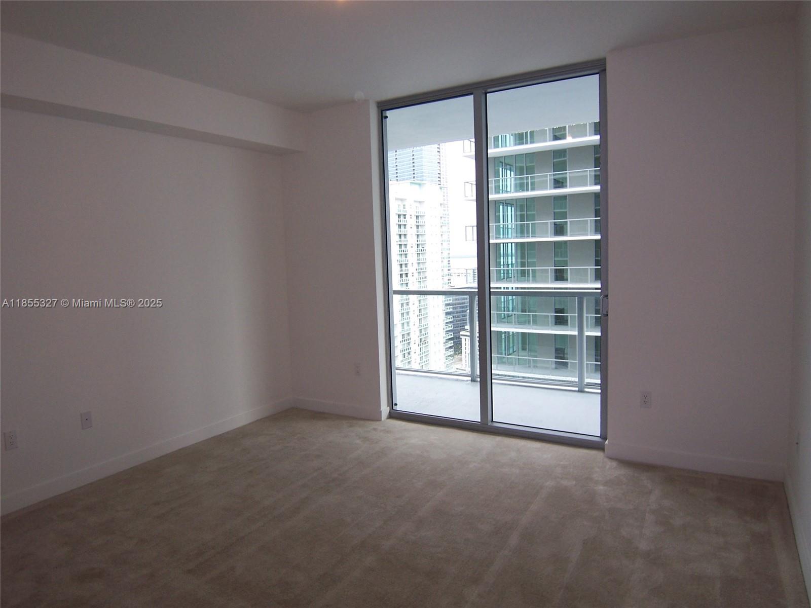 1111 Southwest 1st Avenue, Unit 3415N Miami, FL 33130 - Photo 7 of 11 a view of an empty room with a window