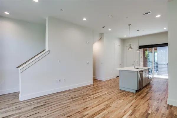 a kitchen with a wooden floor and window