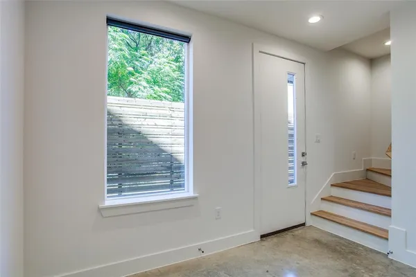 a view of entryway with wooden floor and stairs