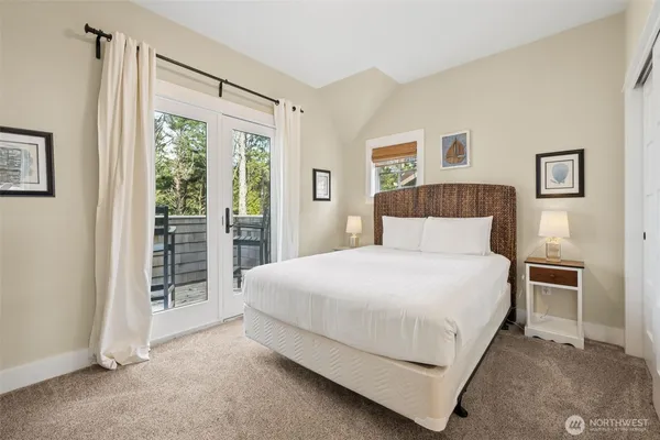 a bedroom with a bed and a large window