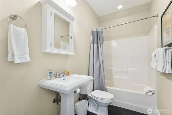 a bathroom with a sink toilet and shower