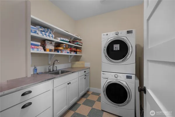 a utility room with sink dryer and washer
