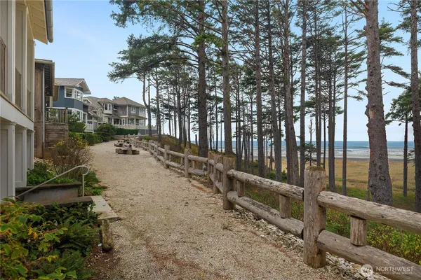 a view of a yard with wooden fence