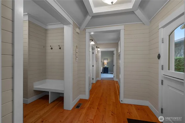 a view of a room with wooden floor and a bathroom