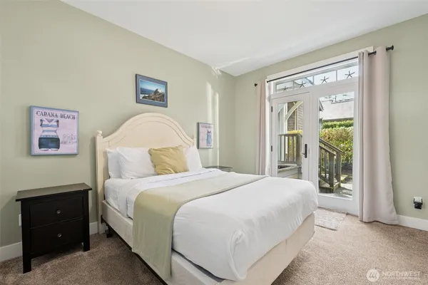 a bedroom with a bed and a large mirror