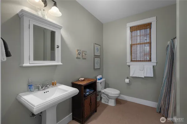 a bathroom with a toilet sink and mirror