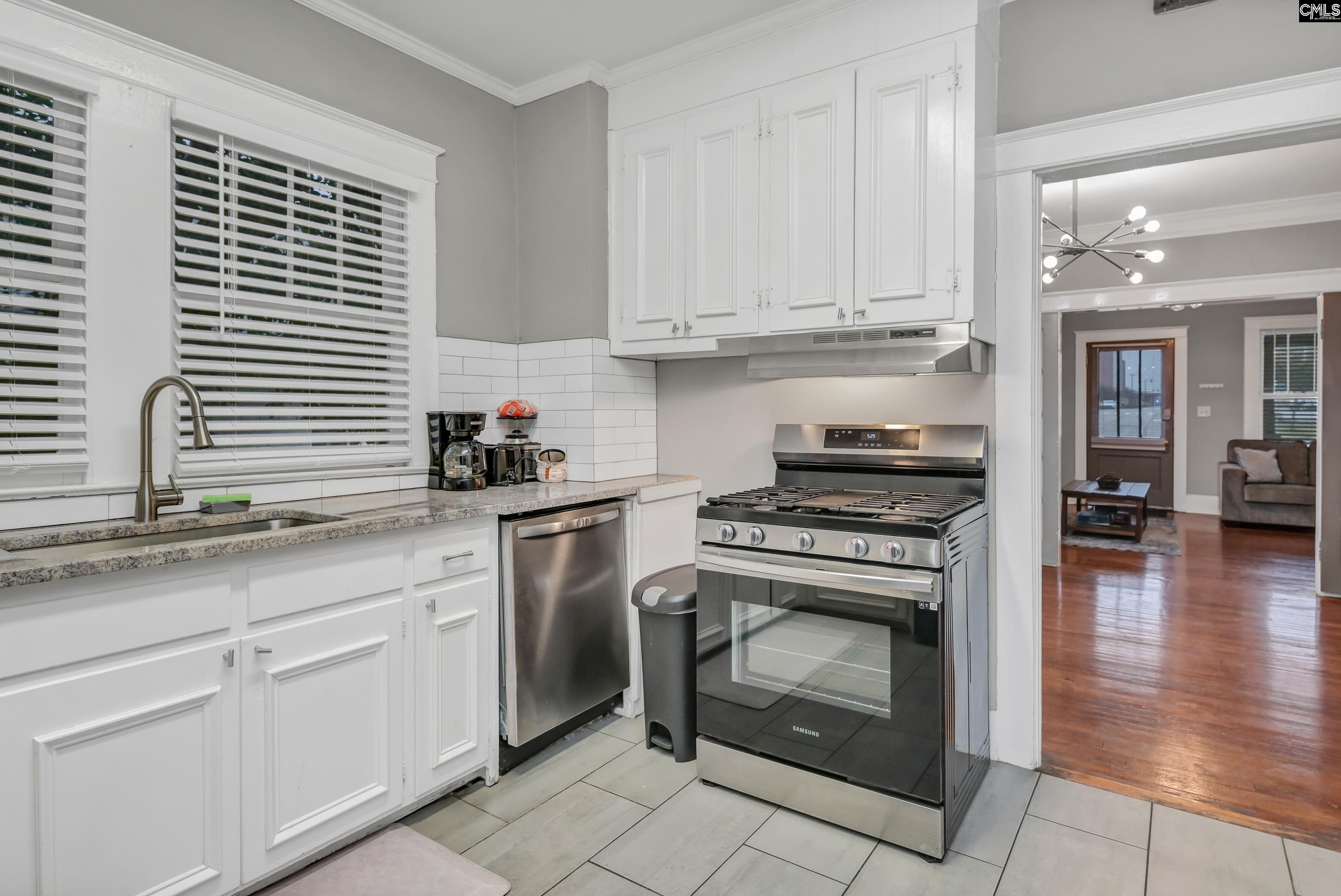 2227 Bull Street Columbia, SC 29201 - Photo 15 of 38 a kitchen with white cabinets and appliances