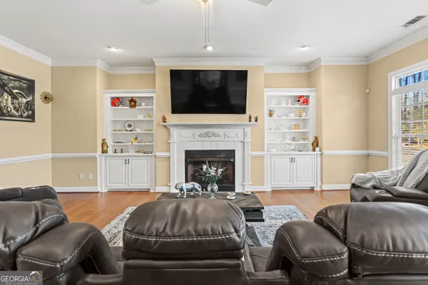 a living room with furniture fireplace and a flat screen tv
