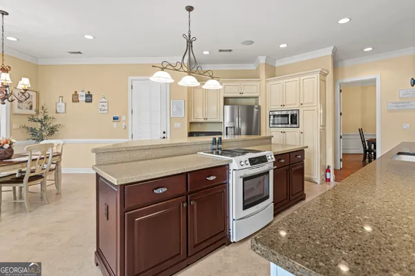 a kitchen with stainless steel appliances granite countertop a stove and a refrigerator