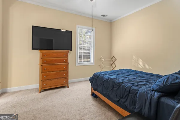 a bedroom with a bed and flat screen tv
