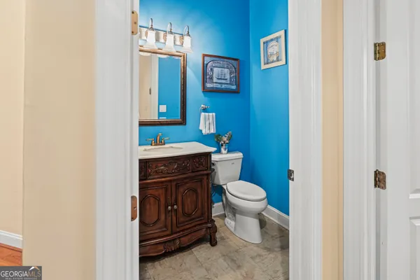 a bathroom with a toilet a sink and a mirror