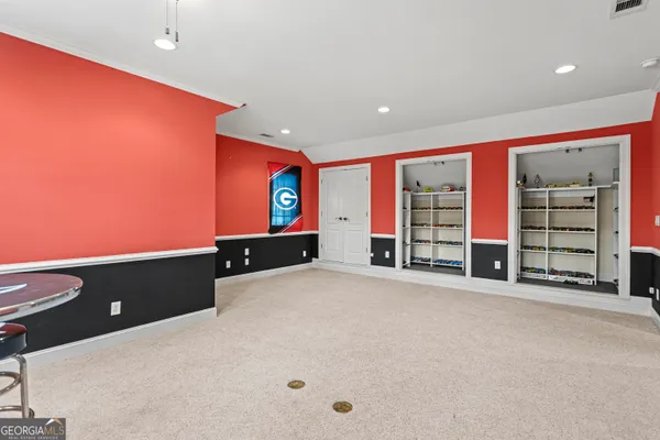 an empty room with furniture and a flat screen tv