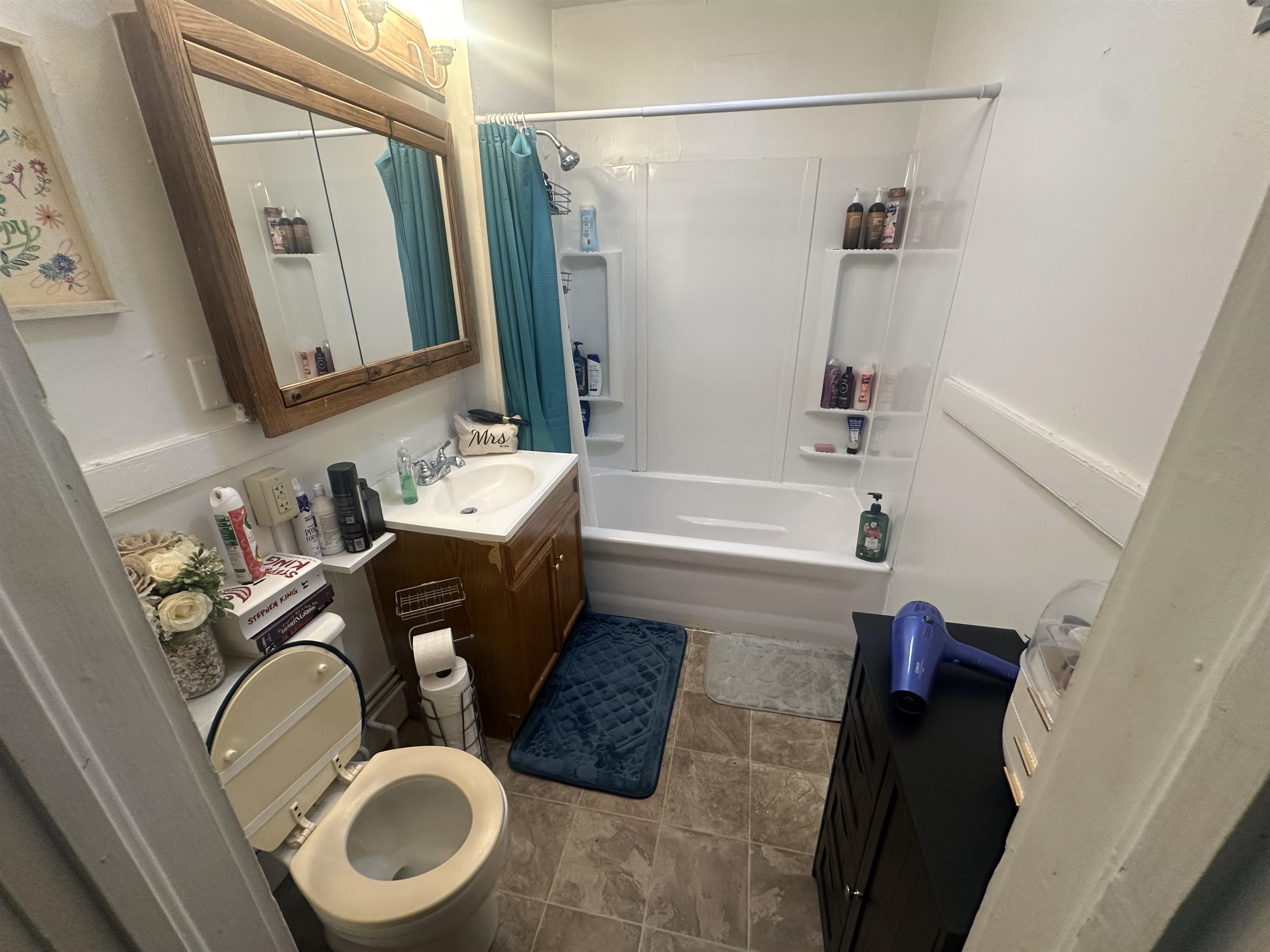 3512 Belknap Street Superior, WI 54880 - Photo 23 of 24 Full bathroom with vanity, shower / bath combination with curtain, and dark tile patterned floors