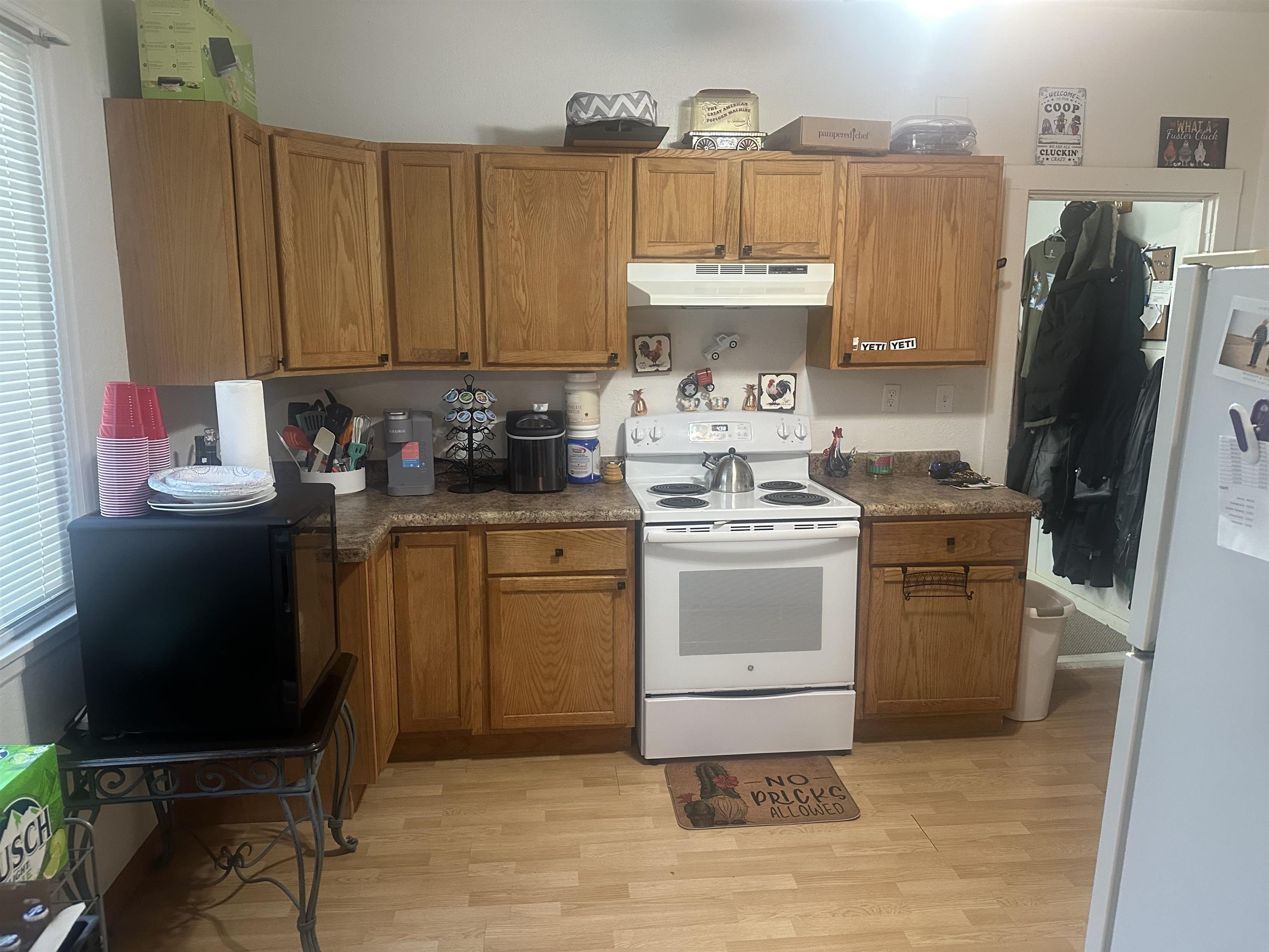 3512 Belknap Street Superior, WI 54880 - Photo 8 of 24 Kitchen featuring white appliances, dark countertops, brown cabinets, and light wood finished floors
