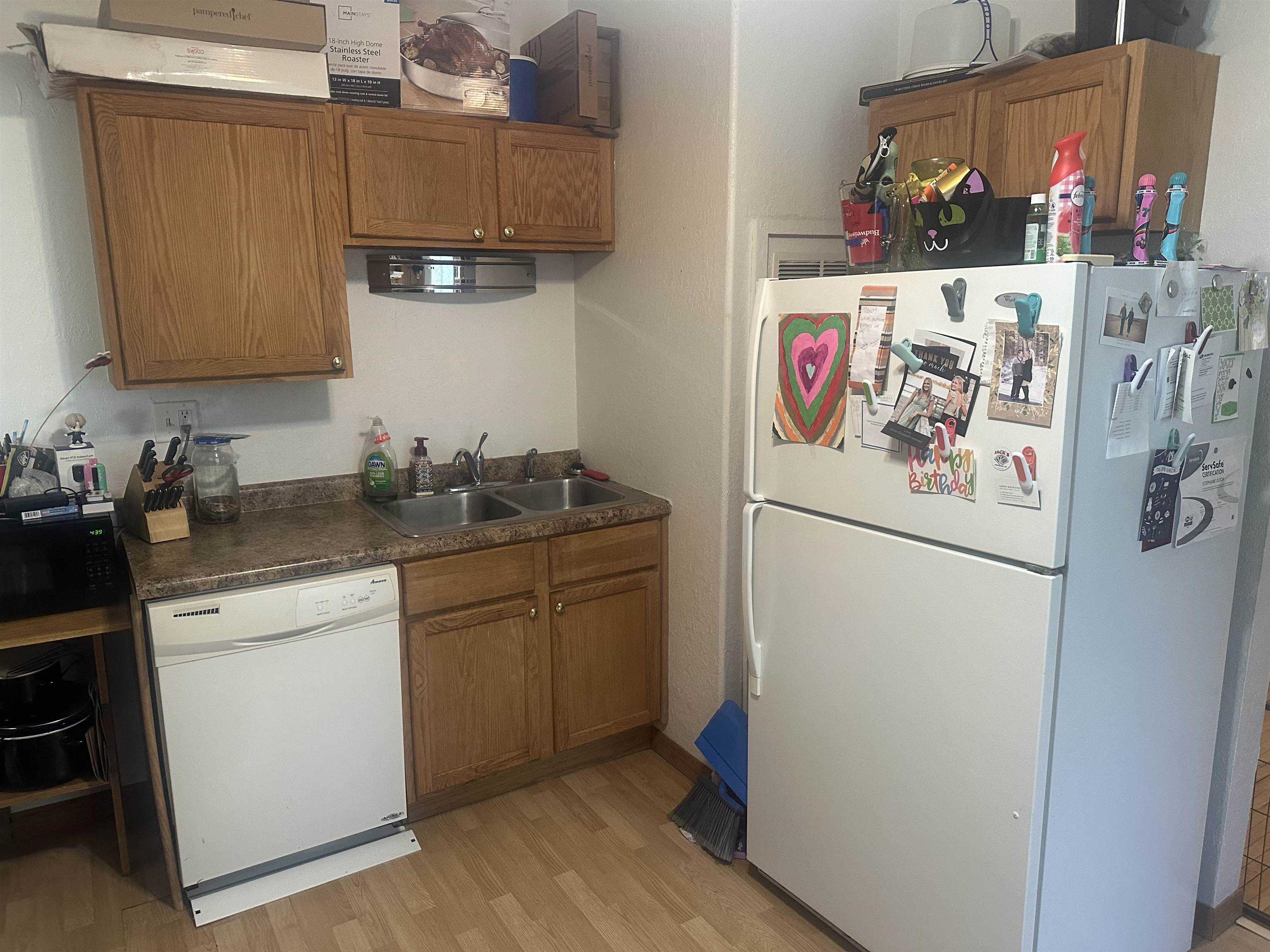 3512 Belknap Street Superior, WI 54880 - Photo 9 of 24 Kitchen featuring white appliances, dark countertops, brown cabinetry, and light wood finished floors