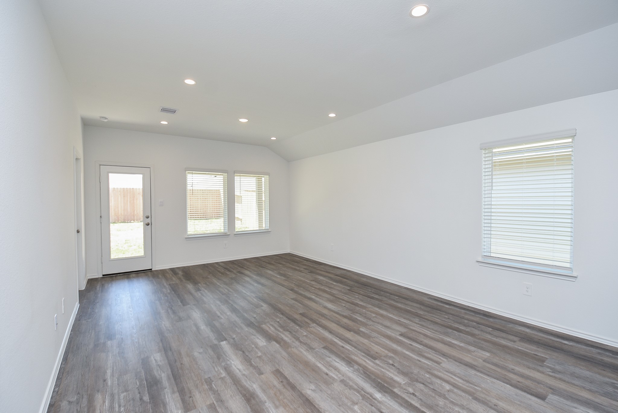 5718 Sycamore Glen Dr Spring Spring, TX 77373 - Photo 11 of 33 an empty room with wooden floor and windows