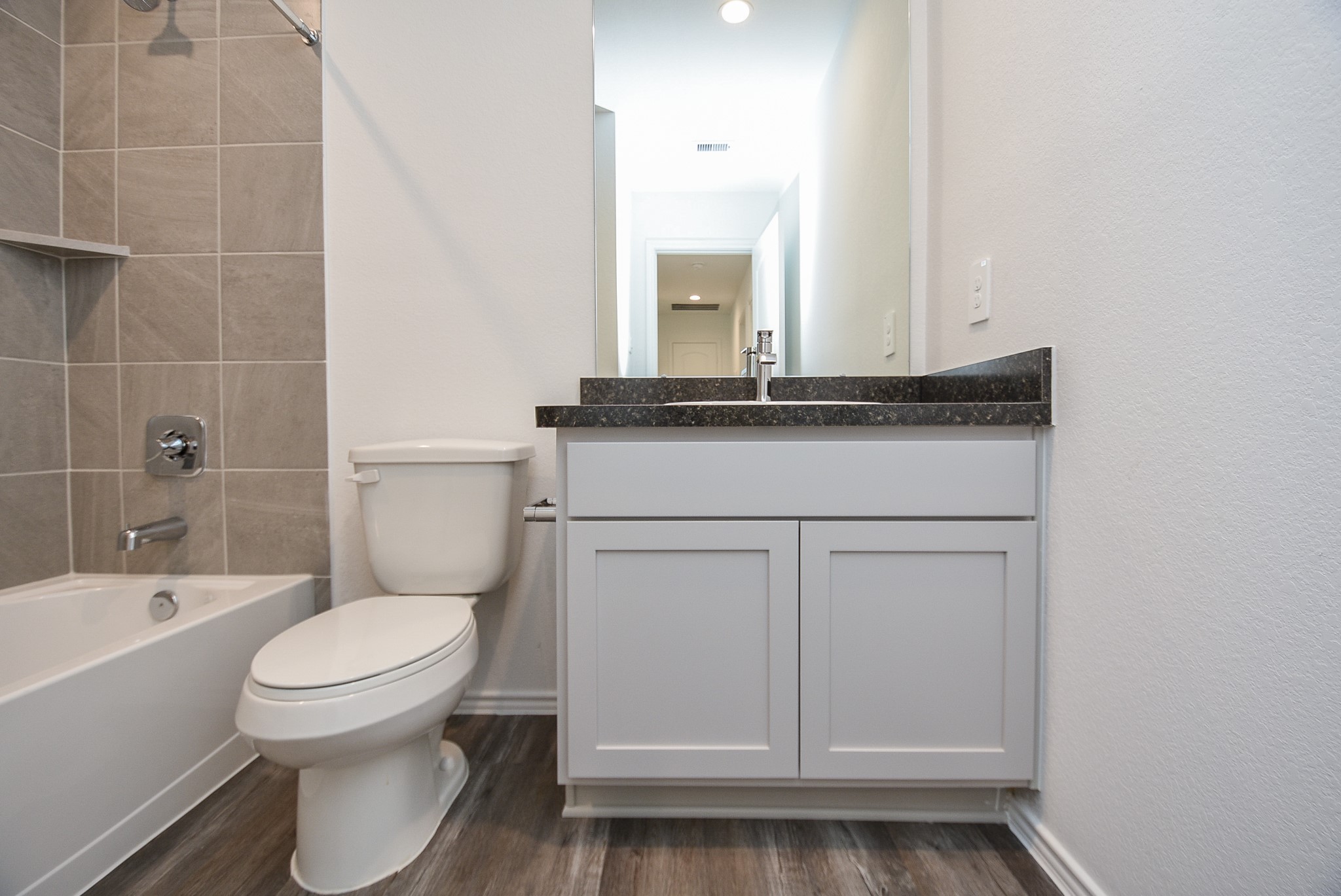 5718 Sycamore Glen Dr Spring Spring, TX 77373 - Photo 25 of 33 a bathroom with a sink toilet vanity and tub