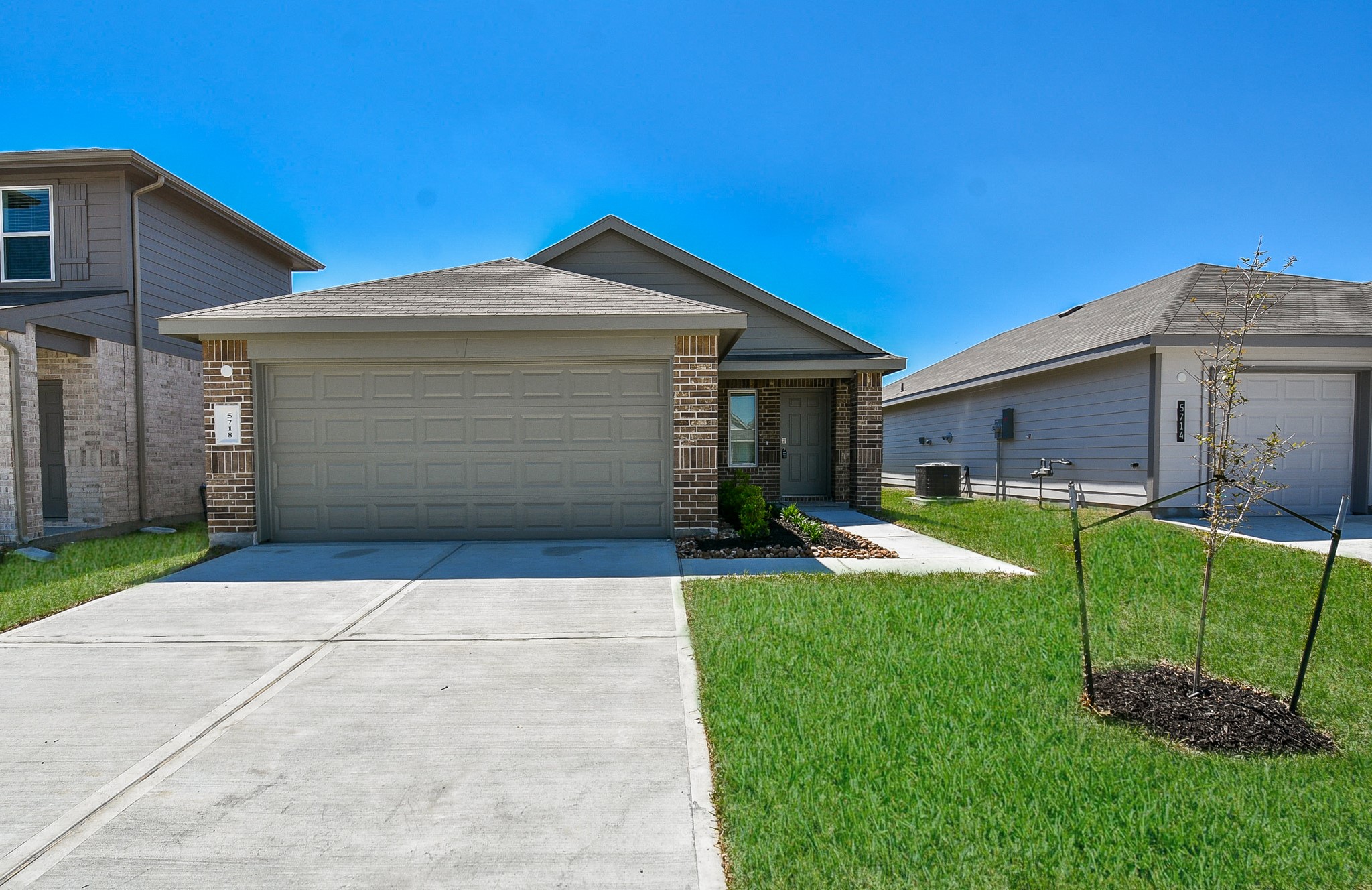 5718 Sycamore Glen Dr Spring Spring, TX 77373 - Photo 32 of 33 a front view of a house with a yard and garage