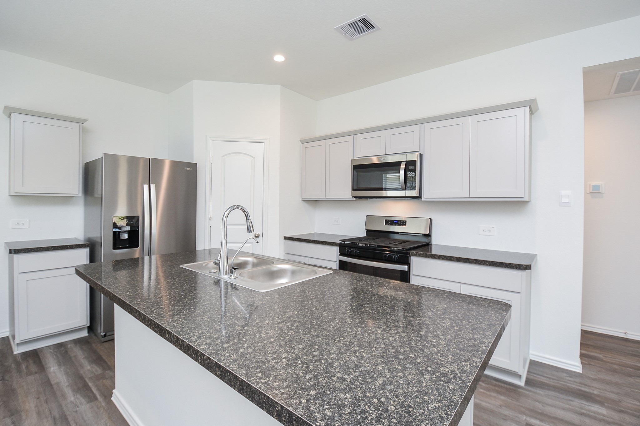 5718 Sycamore Glen Dr Spring Spring, TX 77373 - Photo 4 of 33 a kitchen with granite countertop a refrigerator stove top oven and sink