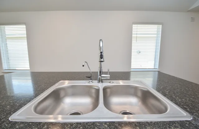 a stove top oven sitting inside of a kitchen